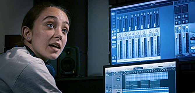 A young woman mixes music digitally
