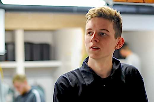 A young man looks forward with expectation