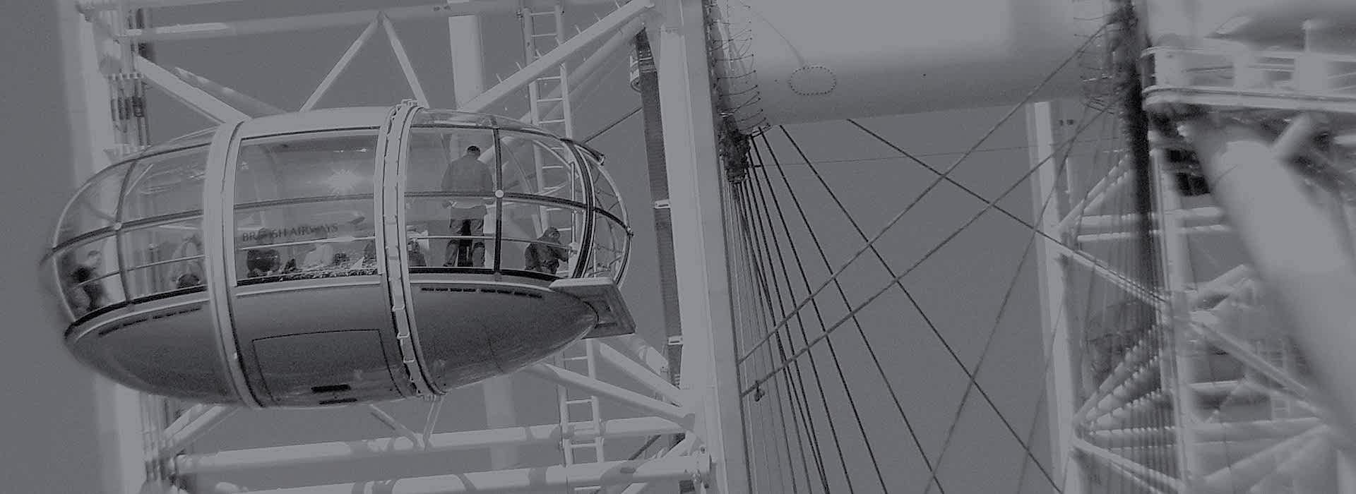 A glass pod on the London Eye glistens in the sun high above the city