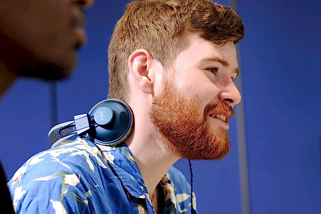 Something off-camera catches the eye of a group of students on the campus grounds 