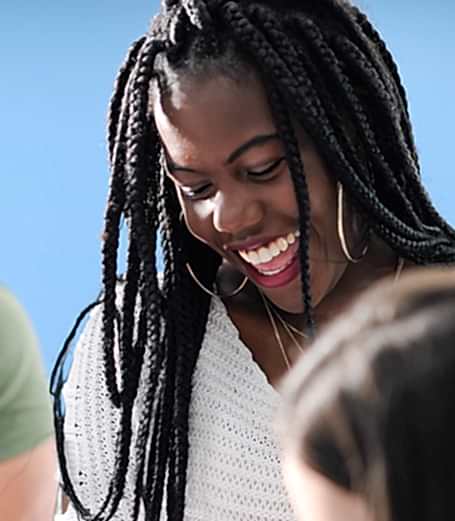 A young woman in a TV control room gets the giggles