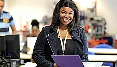 Student reading from a binder