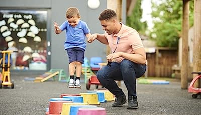A young man work as a child carer at a nursery