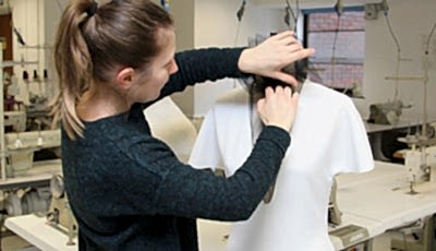 Student making clothing on a mannequin