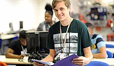 Student reading from a binder