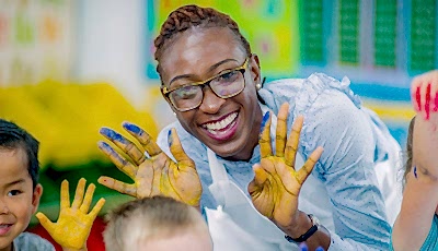 Teacher smiling showing hands